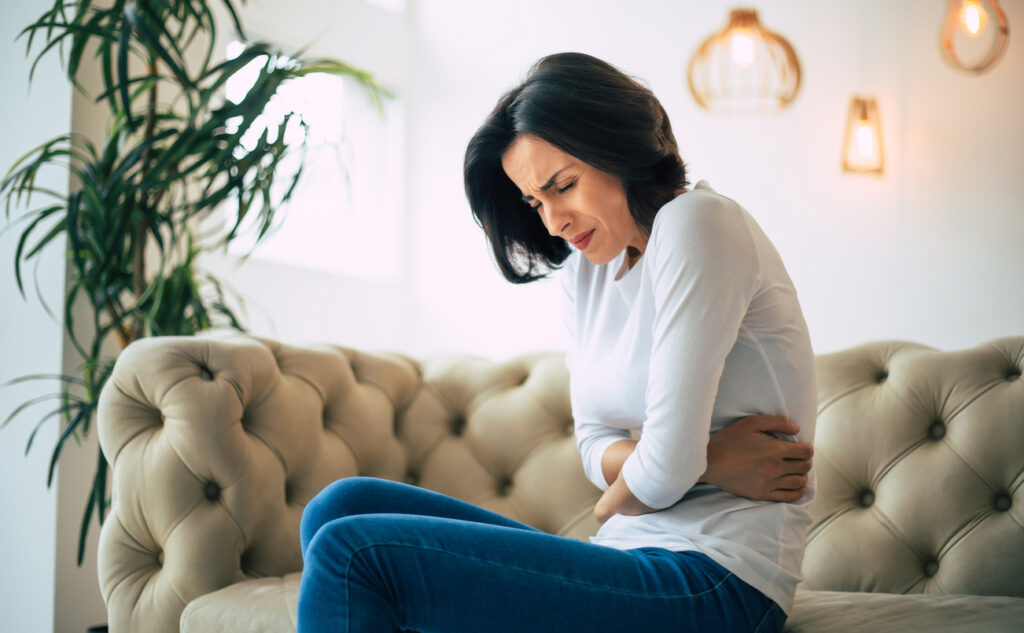 Gut inflammation, woman suffering from pain