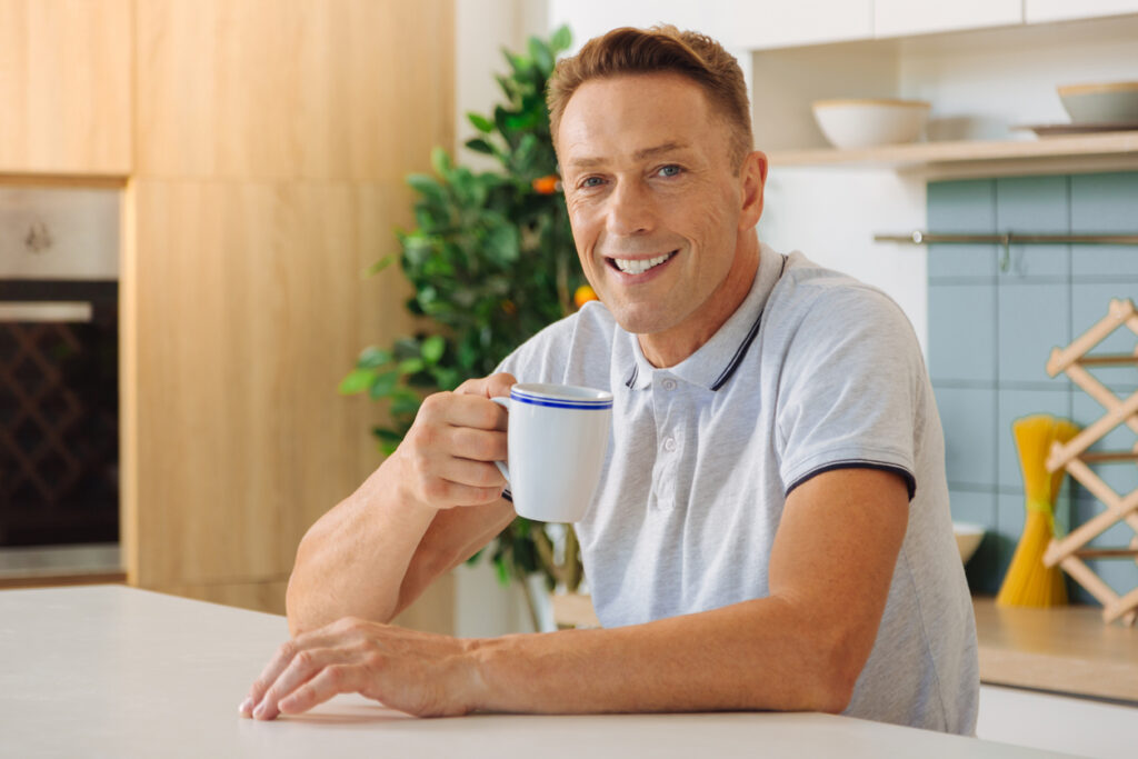 Man drinking herbal tea to soothe gut inflammation and pain