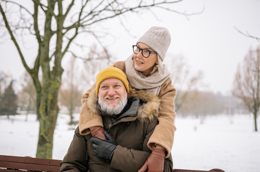 An elderly couple in winter clothing, stiff joints in winter