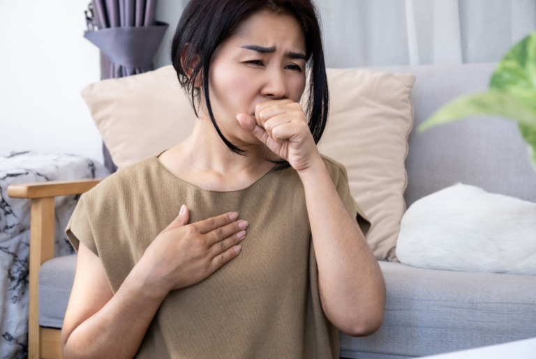 Asian woman with chronic coughing caused by heartburn from acid reflux