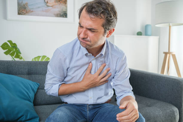 Man having heartburn after large meal, acid reflux, GERD, Health and wellness, mindful eating